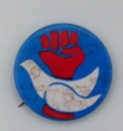 Anti-War Pinback with White Dove in front of a raised red Fist