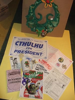 Seller image for CTHULHU GROUPING: Encyclopedia Cthulhiana / Cthulhu for President 1992 / Cthulhu Christmas Wreath / Cthulhu Shotglass & Coffee Mug & Pinback Buttons ( ( H P Lovecraft / Cthulhu Mythos related) book includes: History of the Necronomicon ) for sale by Leonard Shoup