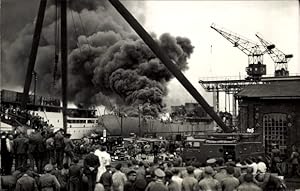 Foto Ansichtskarte / Postkarte Brand von einem Frachter im Hafen