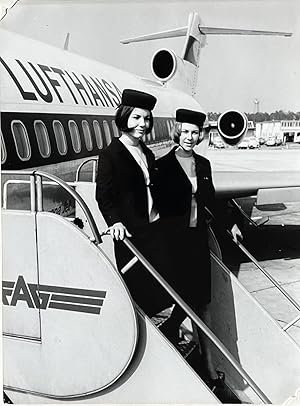 1960s Glossy Black and White Photo of Two Lufthansa Flight Attendants Standing Next to a Jetliner