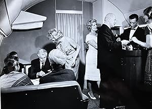 1960s Glossy Black and White Photo of Eight First Class Passengers Enjoying the First Class Bar o...