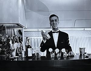 1960s Glossy Black and White Photo of a Bartender in a Lufthansa Airliner First Class Bar Lounge