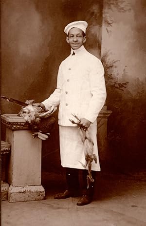 [An African American chef with fowl.]