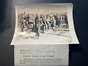 "Prisoners Bringing in their Wounded."