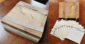 Ten artists' books between thick wooden plates, fixed by two elastic bands. Contributing artists:...