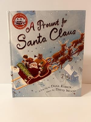 Bild des Verkufers fr A Present for Santa Claus [POP-UP BOOK] [FIRST U.S. EDITION, FIRST PRINTING] zum Verkauf von Vero Beach Books