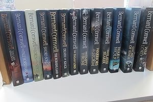 Immagine del venditore per The Warrior chronicles (Saxon tales): 13 hardback books [Last Kingdom: Pale horseman: Lords of the North: Sword song: Burning land: Death of Kings: Pagan lord: Empty throne: Warriors of the storm: Flame bearer: War of the Wolf: Sword of Kings War Lord] venduto da Aucott & Thomas