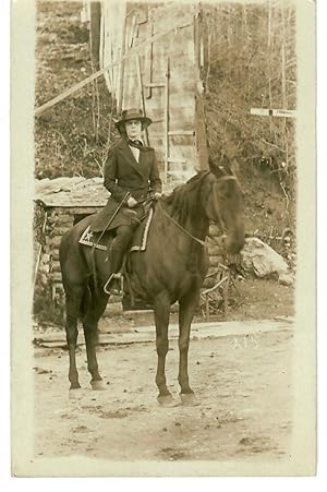 Seller image for [Real Photo Postcard--Natty Woman Astride on Horseback in Front of Log Shed and Partial Wall] for sale by Robin Bledsoe, Bookseller (ABAA)