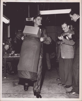 Elvis Presley receiving his uniform at Fort Chaffee, Arkansas. Original photograph.