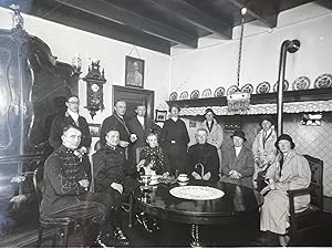 Photography 20th century | Photograph of a group in a Dutch interior titled Na een jachtrit in de...