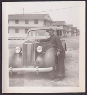 Seller image for Man in uniform polishes a 1937 Packard Sedan vernacular snapshot for sale by The Jumping Frog