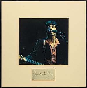 The autograph of Paul McCartney displayed in a frame with a reproduction colour portrait photograph