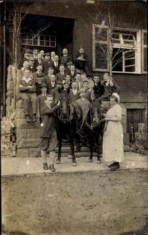 Foto Ansichtskarte / Postkarte Gruppenaufnahme von Männern und Frauen vor einem Gebäude, Pferde