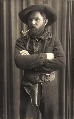 Foto Ansichtskarte / Postkarte Mann mit einer Pfeife, Cowboy, Revolver