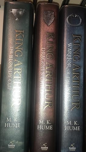 Seller image for The King Arthur Trilogy: DRAGONS CHILD + Warrior of the West + Blood Cup. All Three are First Editions, First Impressions With Dustwrappers. VG+/Fine. for sale by Ely Books