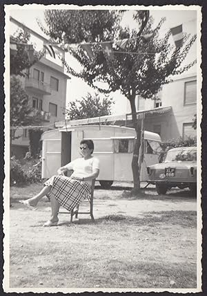 Italy 1960, Liguria, Woman sitting in front of car with caravan, Vintage photography