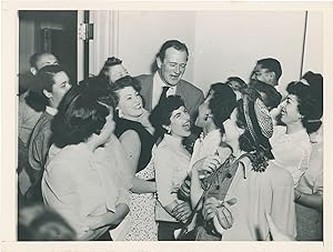 Original press photograph of John Wayne surrounded by admirers, 1953
