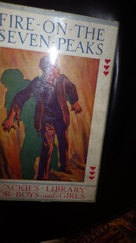 Imagen del vendedor de Fire on the Seven Peaks in Color Dustjacket OF BOY Standing With His Back & Hands to WALL IN BROWN SUIT with Green Silhouette of His Shadow Behind Him. Blackie's Library For Boys & Girls.Glossy Frontispiece by John de Walton a la venta por Bluff Park Rare Books
