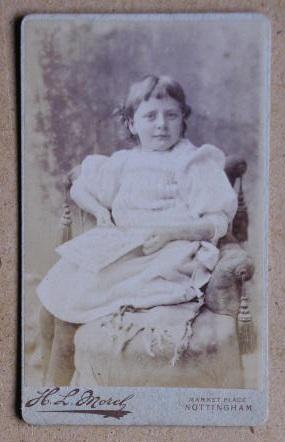 Imagen del vendedor de Carte De Visite Photograph. Portrait of a Young Girl Seated on a Chair. a la venta por N. G. Lawrie Books