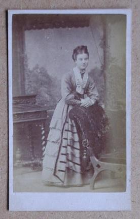 Carte De Visite Photograph. Portrait of a Young Woman Standing Beside a Chair.
