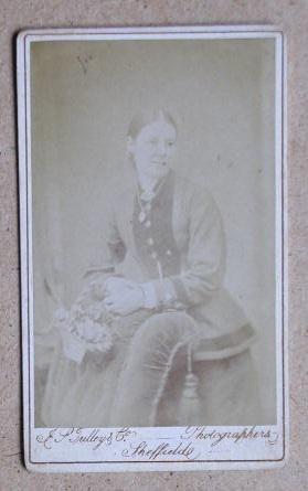 Bild des Verkufers fr Carte De Visite Photograph. Portrait of a Young Woman Holding a Basket of Flowers. zum Verkauf von N. G. Lawrie Books