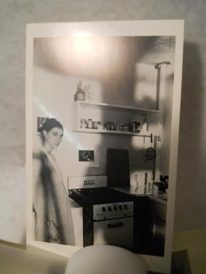 Bild des Verkufers fr Unititled (woman in kitchen) [photo postcard] zum Verkauf von Gil's Book Loft