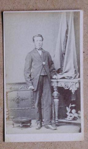 Bild des Verkufers fr Carte De Visite Photograph. Portrait of a Young Man Standing Beside a Table. zum Verkauf von N. G. Lawrie Books