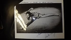 Seller image for SIGNED B/W Glossy PHOTO of Beautiful Paula Kelly of Black Dancer on Floor Holding Flower with arm outstretched in Skimpy Dress, SHE WAS DANCER IN SWEET CHARITY ON BROADWAY ALSO, Original Dancer featured in N.E.T. USA DANCE ECHOES OF JAZZ performing Donald for sale by Bluff Park Rare Books
