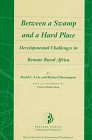 Stock image for Between a Swamp and a Hard Place: Developmental Challenges in Remote Rural Africa for sale by BookHolders